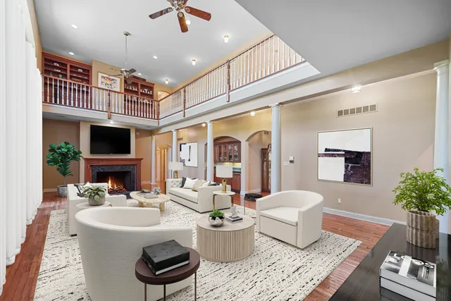 a living room with furniture wooden floor and a potted plant
