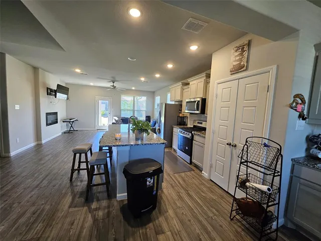 a view of a dining room with furniture a rug and wooden floor