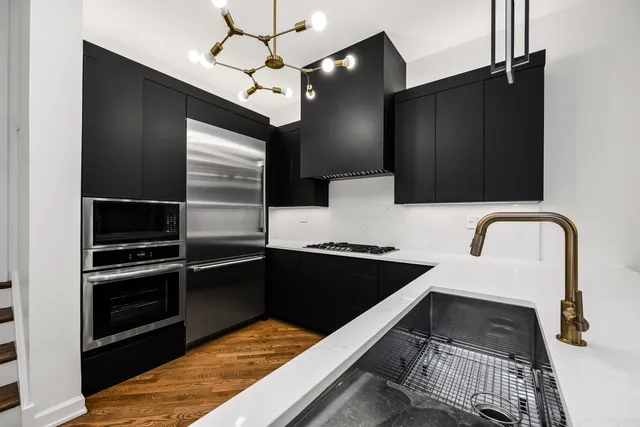 a kitchen with granite countertop stainless steel appliances and sink
