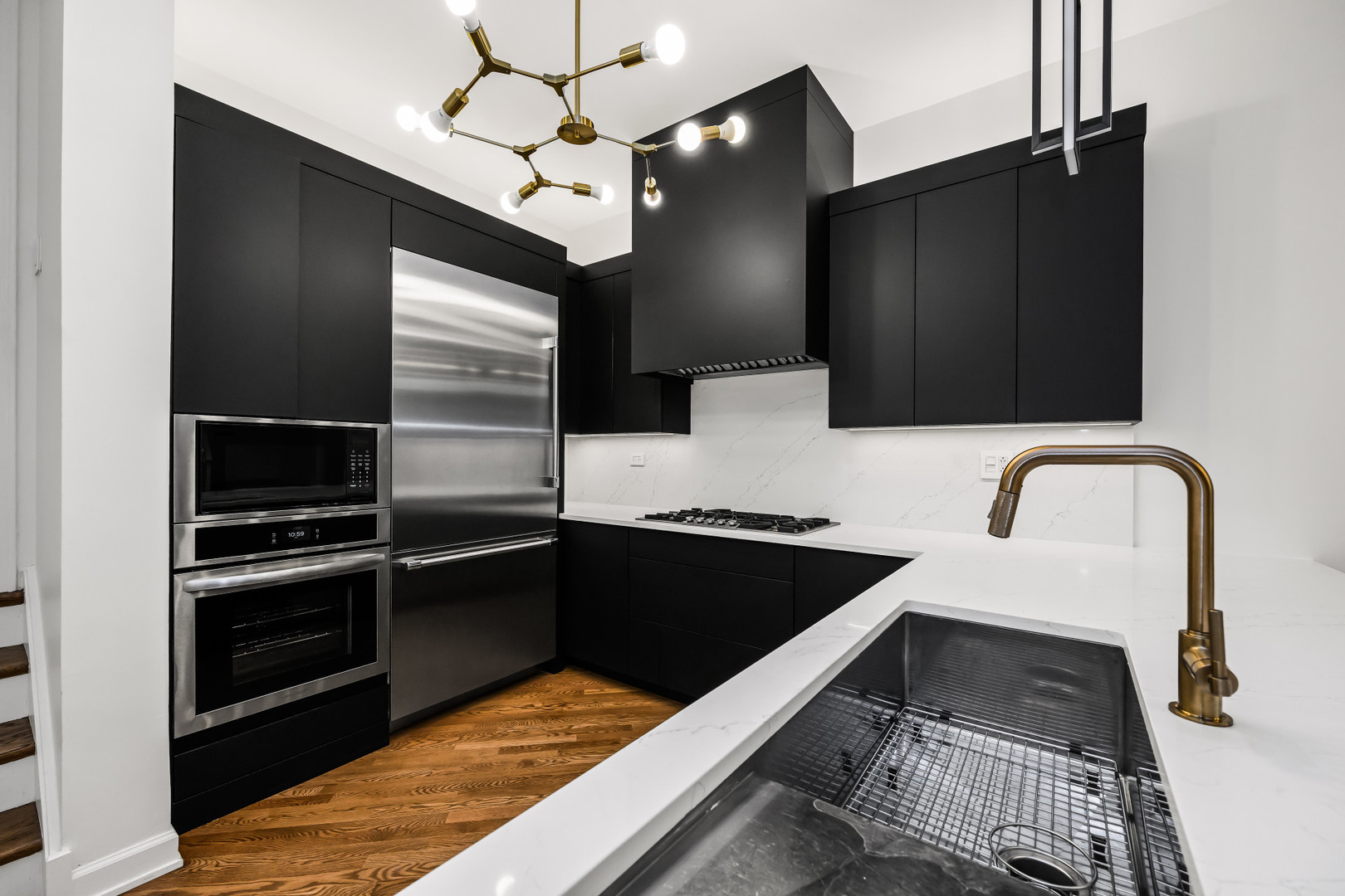 363 West Superior Street, Unit A Chicago, IL 60654 - Photo 5 of 18 a kitchen with granite countertop stainless steel appliances and sink