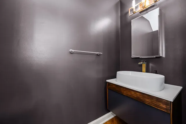 a bathroom with a sink a mirror and vanity