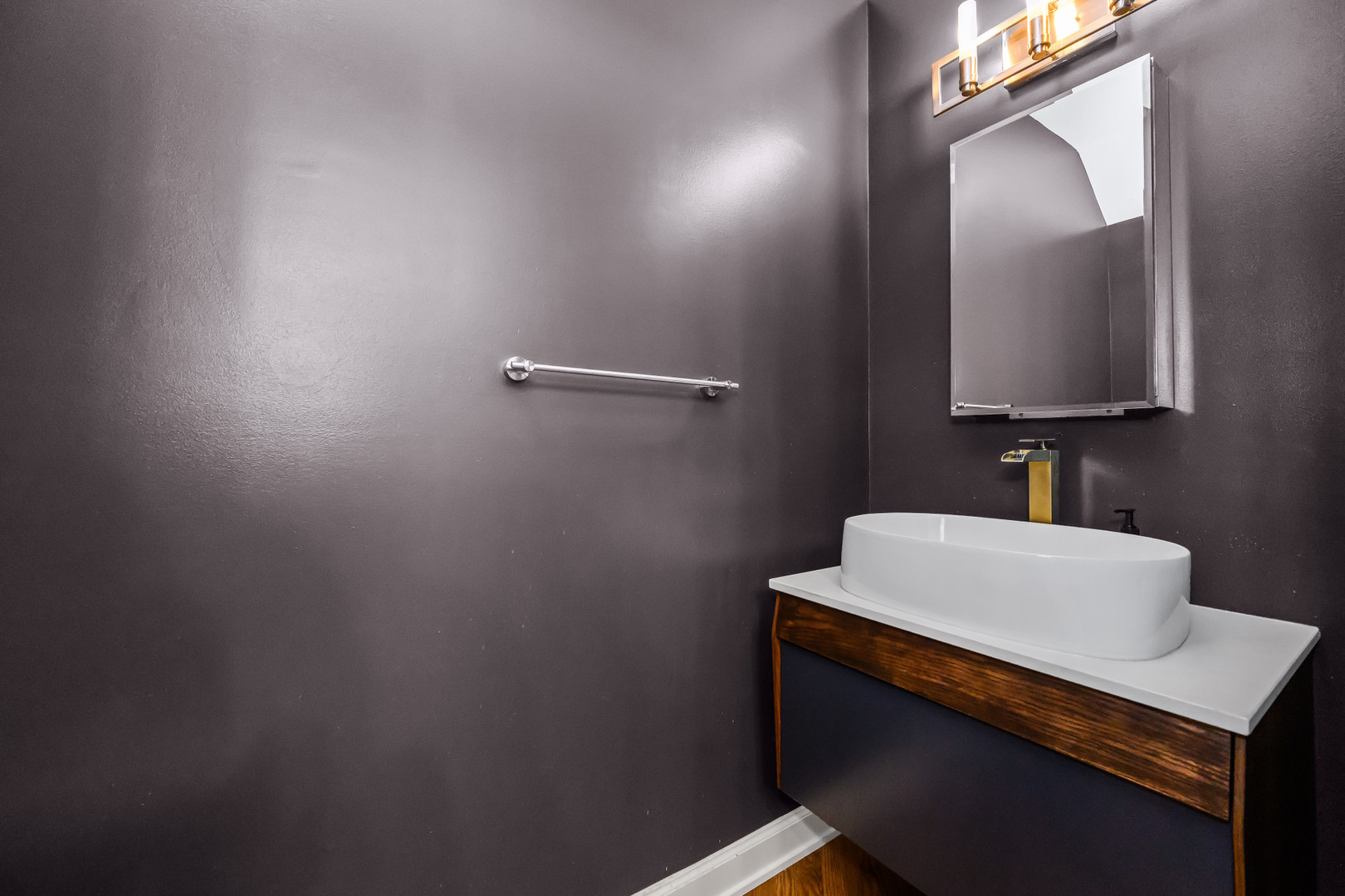 363 West Superior Street, Unit A Chicago, IL 60654 - Photo 6 of 18 a bathroom with a sink a mirror and vanity