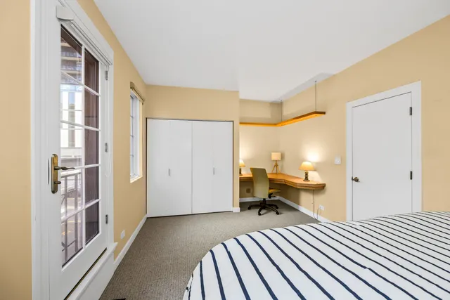 a bedroom with furniture and a window