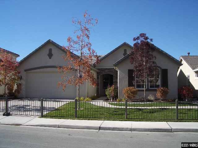 10631 Fort Morgan Way, Unit 1 Reno, NV 89521 - Photo 1 of 6 a front view of a house with a garden and plants