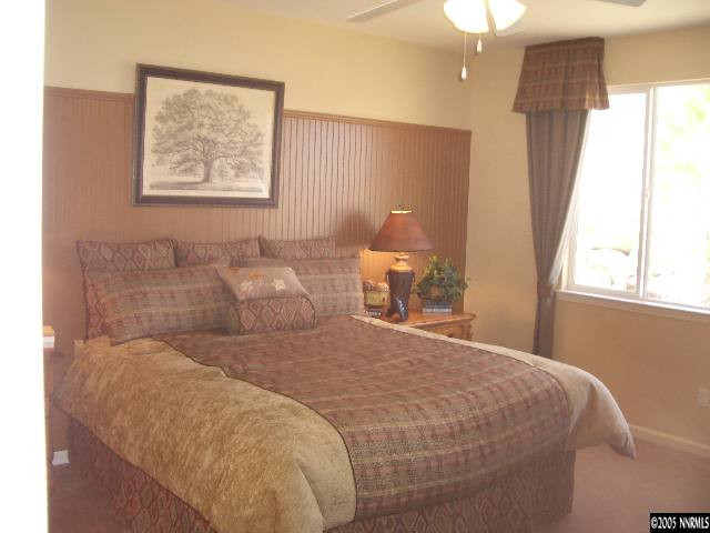 10631 Fort Morgan Way, Unit 1 Reno, NV 89521 - Photo 2 of 6 a bedroom with a bed and a window
