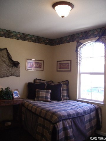 10631 Fort Morgan Way, Unit 1 Reno, NV 89521 - Photo 5 of 6 a bedroom with bed and window
