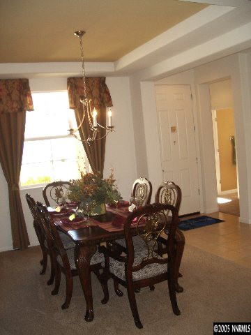 10631 Fort Morgan Way, Unit 1 Reno, NV 89521 - Photo 6 of 6 a view of a dining room with furniture and chandelier