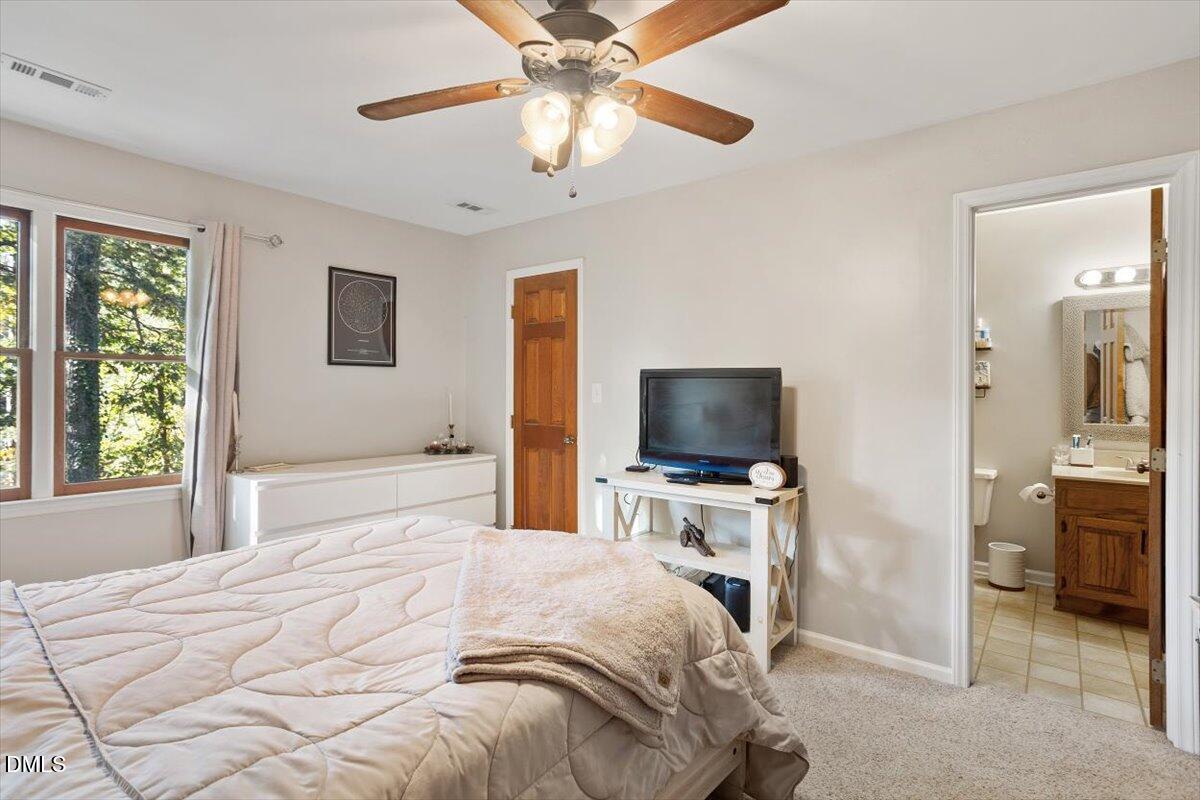 5442 Sharpe Drive Raleigh, NC 27612 - Photo 11 of 20 a bedroom with a bed and a flat screen tv