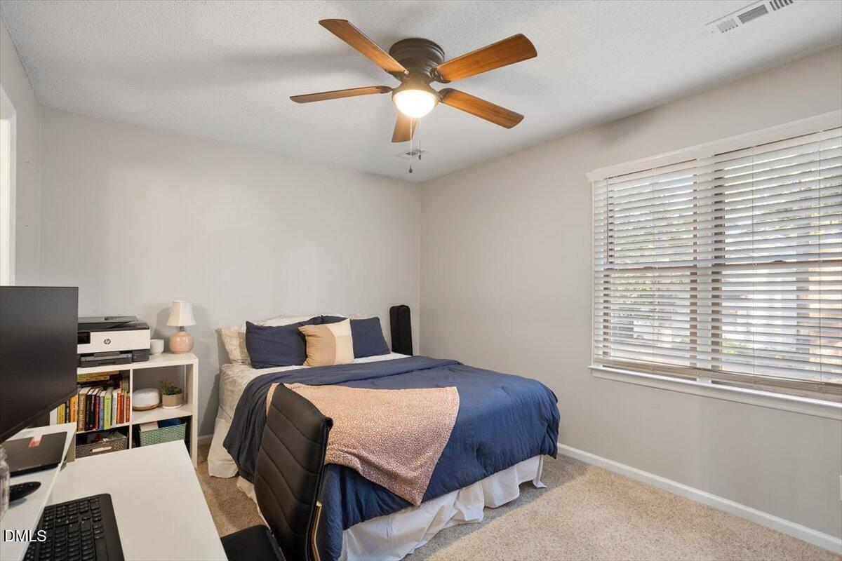 5442 Sharpe Drive Raleigh, NC 27612 - Photo 13 of 20 a bedroom with a bed and a window