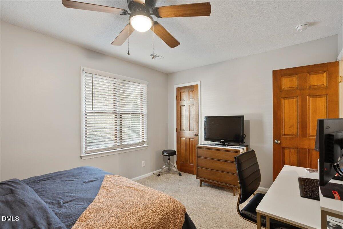 5442 Sharpe Drive Raleigh, NC 27612 - Photo 14 of 20 a bedroom with a bed and a flat screen tv