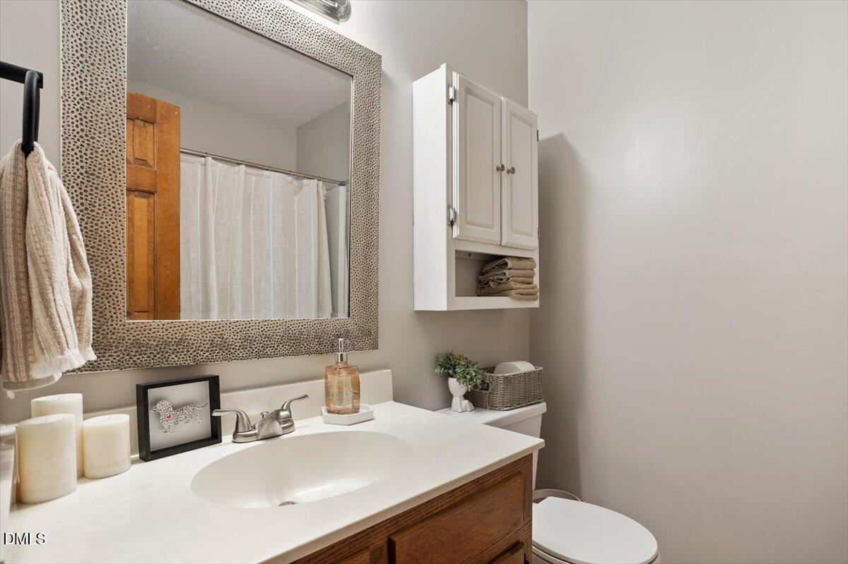 5442 Sharpe Drive Raleigh, NC 27612 - Photo 15 of 20 a bathroom with a sink toilet and mirror