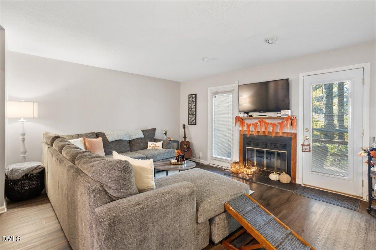 5442 Sharpe Drive Raleigh, NC 27612 - Photo 6 of 20 a living room with furniture and a flat screen tv