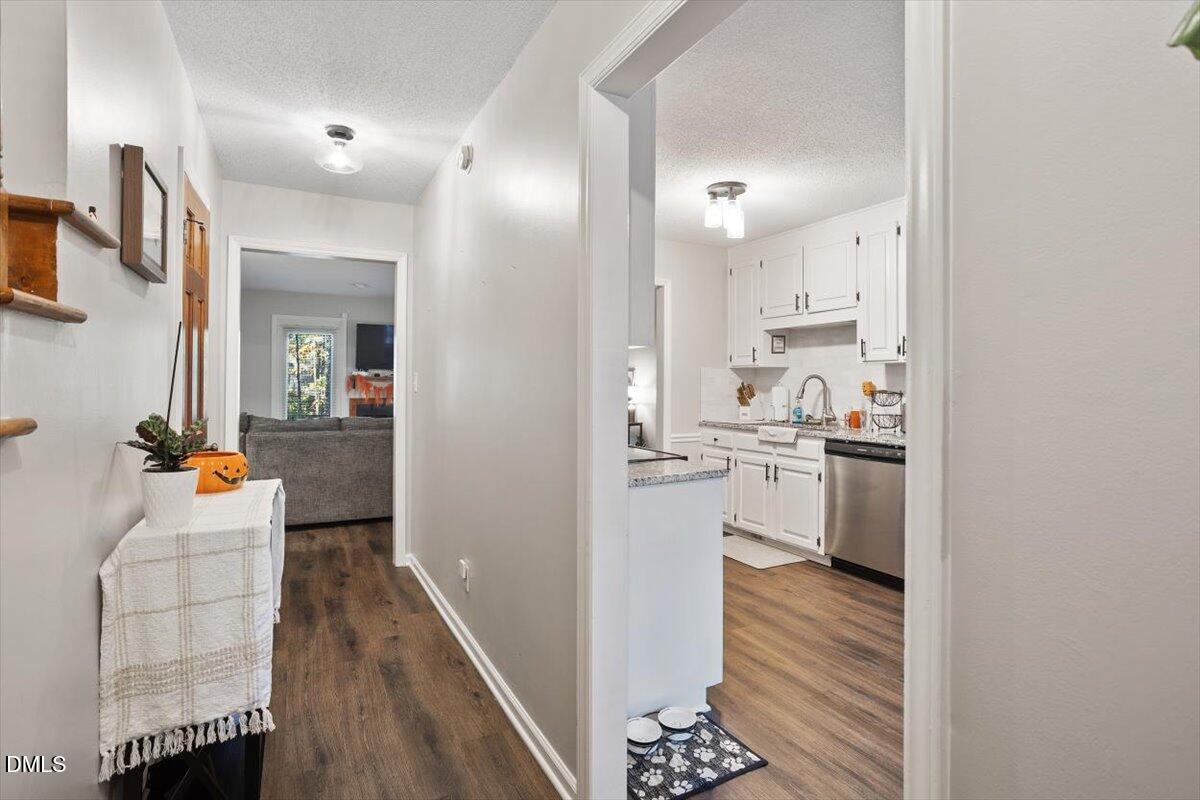 5442 Sharpe Drive Raleigh, NC 27612 - Photo 8 of 20 a view of a living room kitchen and a wooden floor