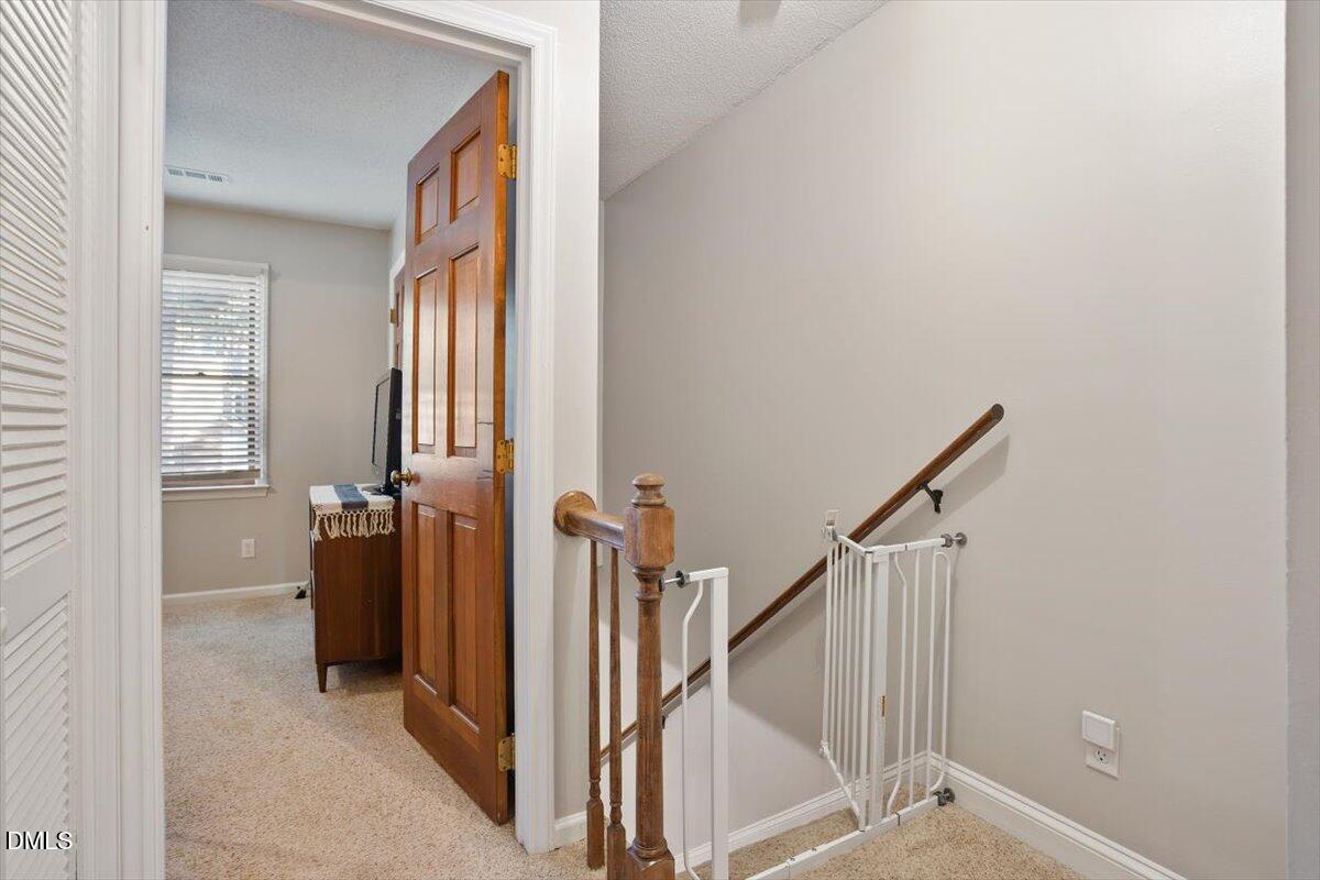 5442 Sharpe Drive Raleigh, NC 27612 - Photo 9 of 20 a view of a hallway with closet and a livingroom view