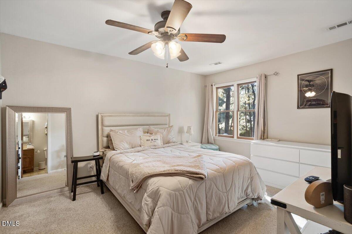 5442 Sharpe Drive Raleigh, NC 27612 - Photo 10 of 20 a bedroom with a bed and a table