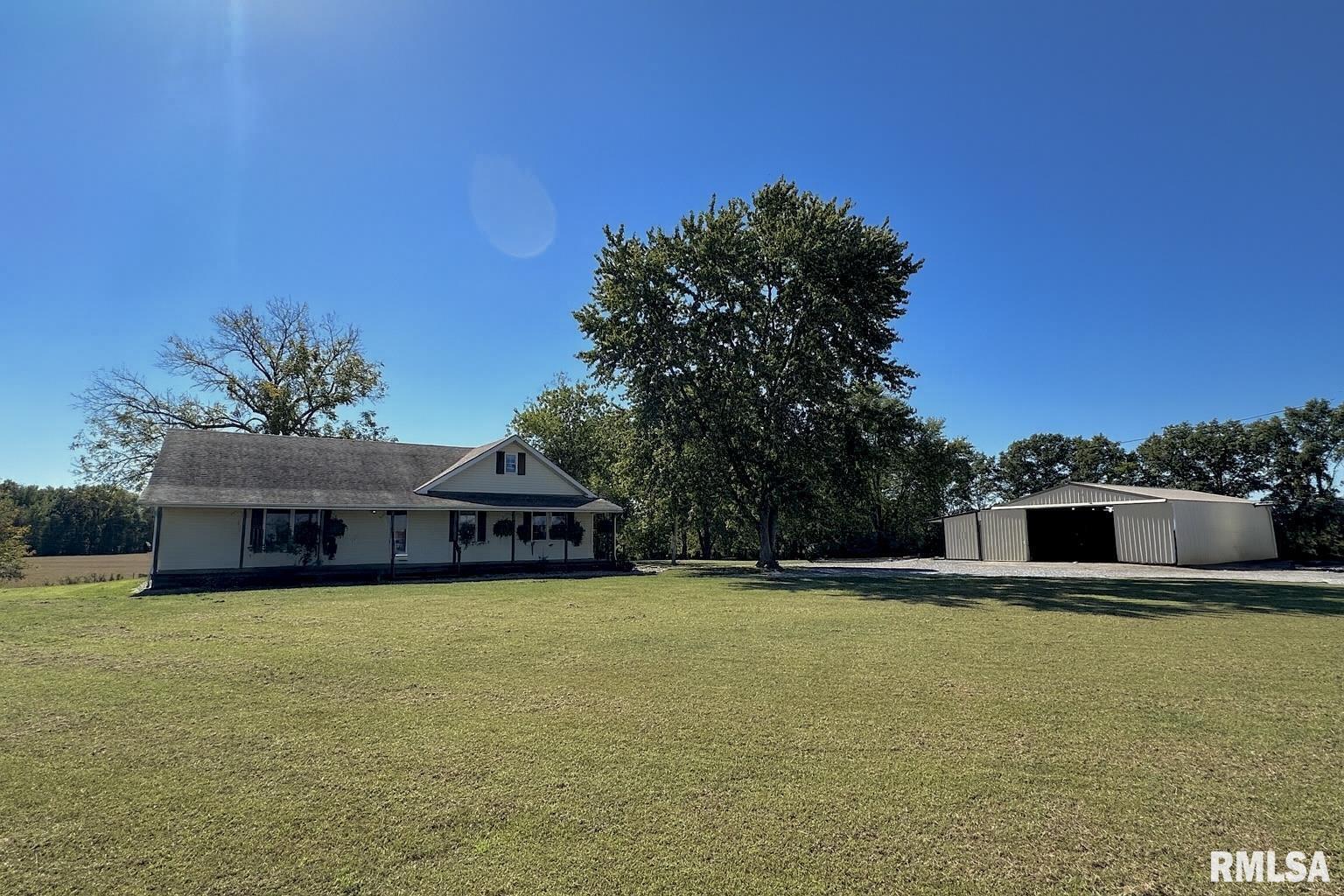878 County Road 600N Sims, IL 62886 - Photo 8 of 82 a view of a swimming pool with an outdoor seating and house in the background