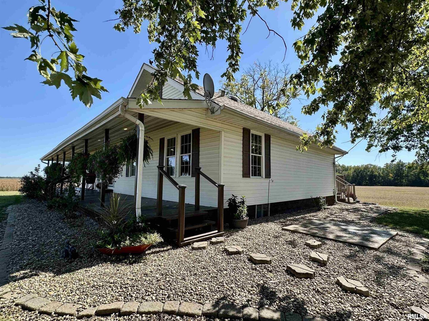 878 County Road 600N Sims, IL 62886 - Photo 10 of 82 a view of a white house with a yard and potted plants