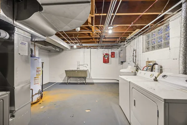 a utility room with cabinets dryer and washer