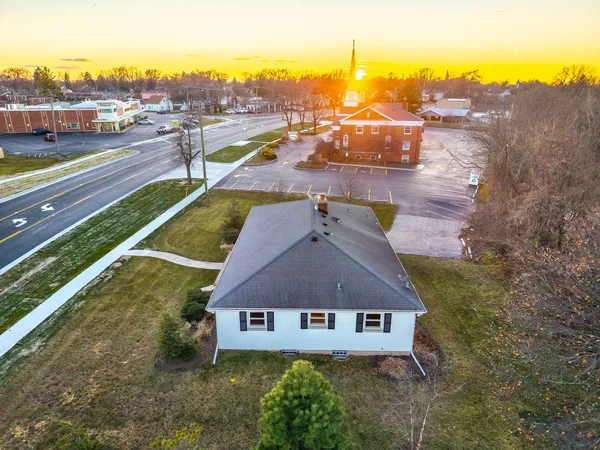 an aerial view of residential houses with outdoor space and street view