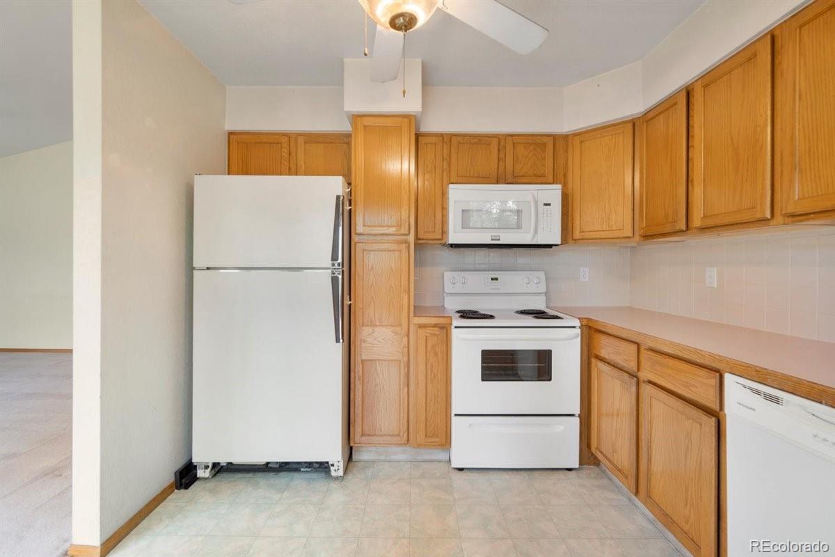 833 Wade Road Longmont, CO 80503 - Photo 15 of 40 a kitchen with a stove and a refrigerator