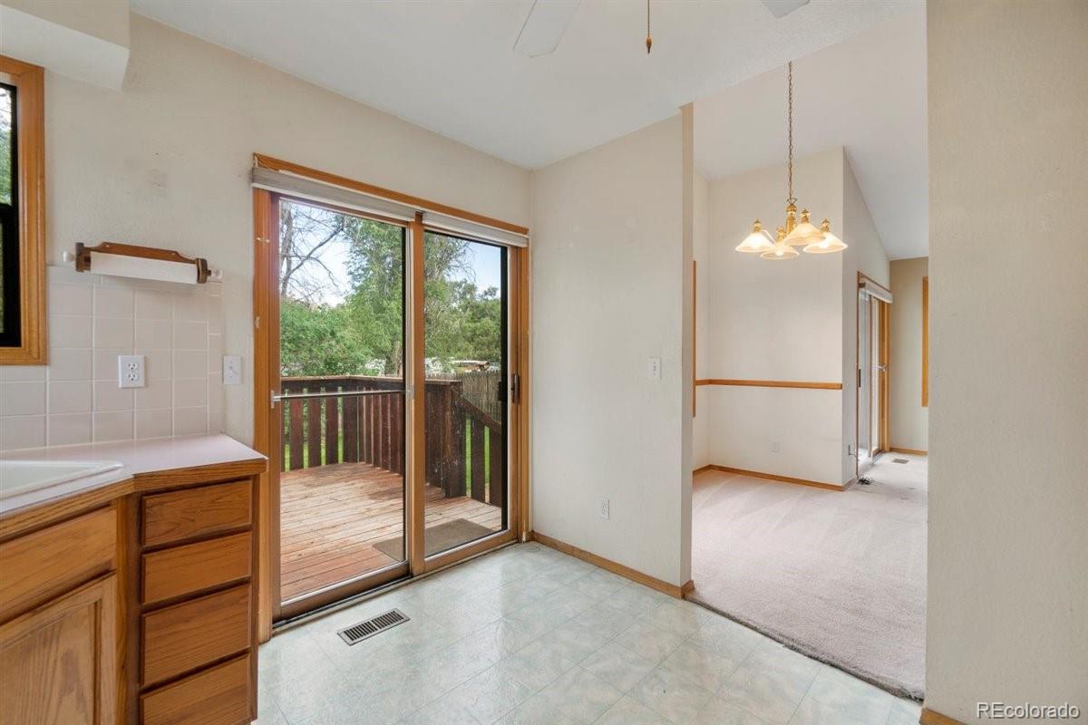 833 Wade Road Longmont, CO 80503 - Photo 16 of 40 a view of a room with a balcony and chandelier