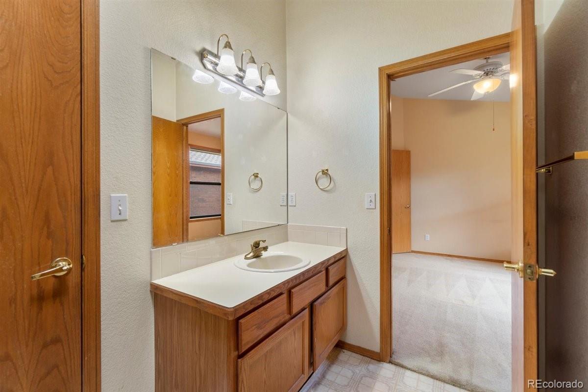 833 Wade Road Longmont, CO 80503 - Photo 21 of 40 a bathroom with a sink and a mirror