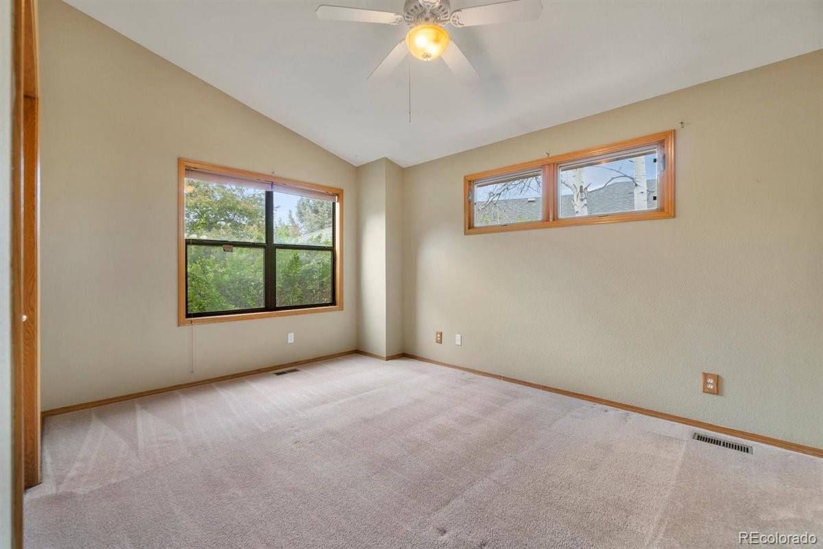 833 Wade Road Longmont, CO 80503 - Photo 23 of 40 an empty room with windows