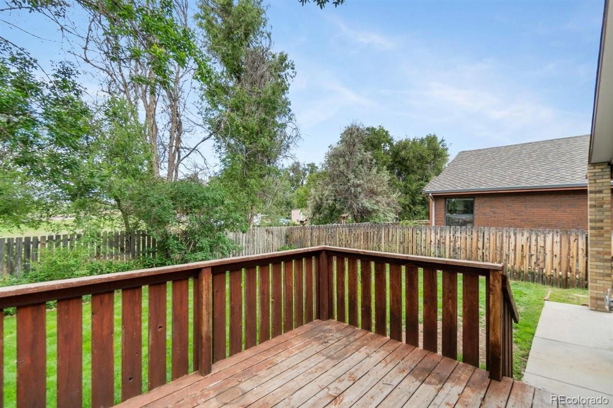833 Wade Road Longmont, CO 80503 - Photo 31 of 40 a balcony with wooden floor and wooden fence