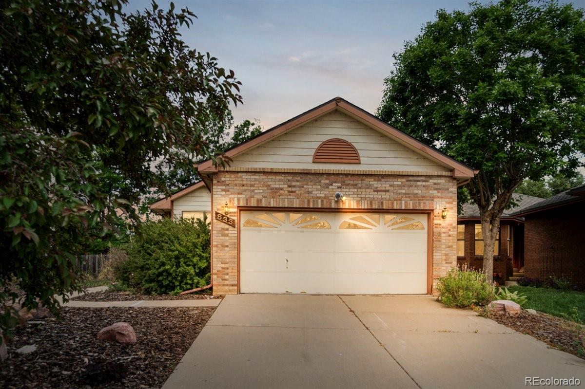 833 Wade Road Longmont, CO 80503 - Photo 4 of 40 a front view of a house with a garden