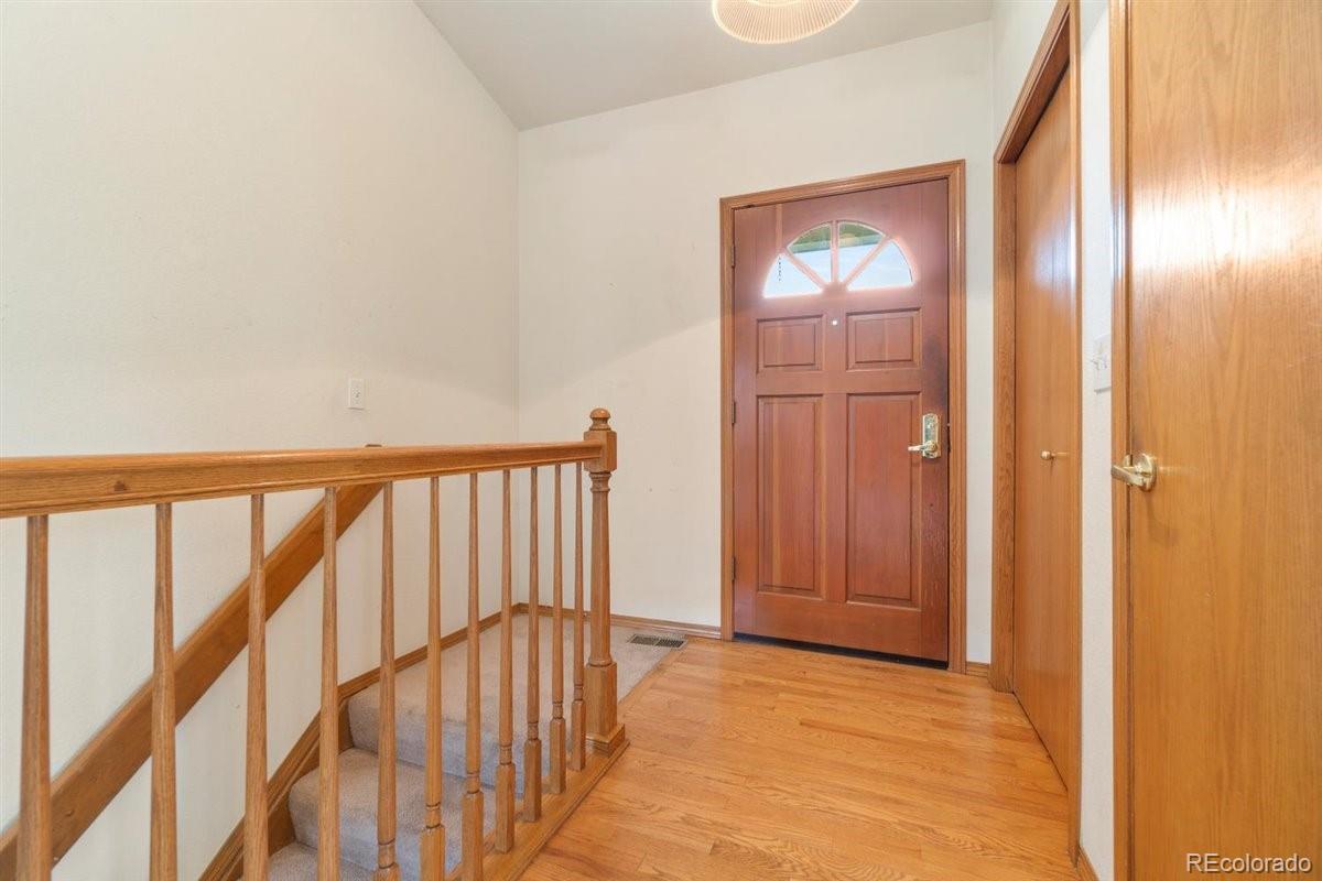 833 Wade Road Longmont, CO 80503 - Photo 6 of 40 a view of a hallway with wooden floor and windows
