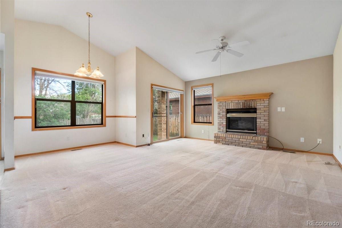 833 Wade Road Longmont, CO 80503 - Photo 8 of 40 a view of an empty room with a window and fireplace