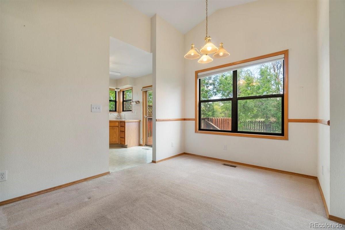 833 Wade Road Longmont, CO 80503 - Photo 9 of 40 an empty room with windows and yard