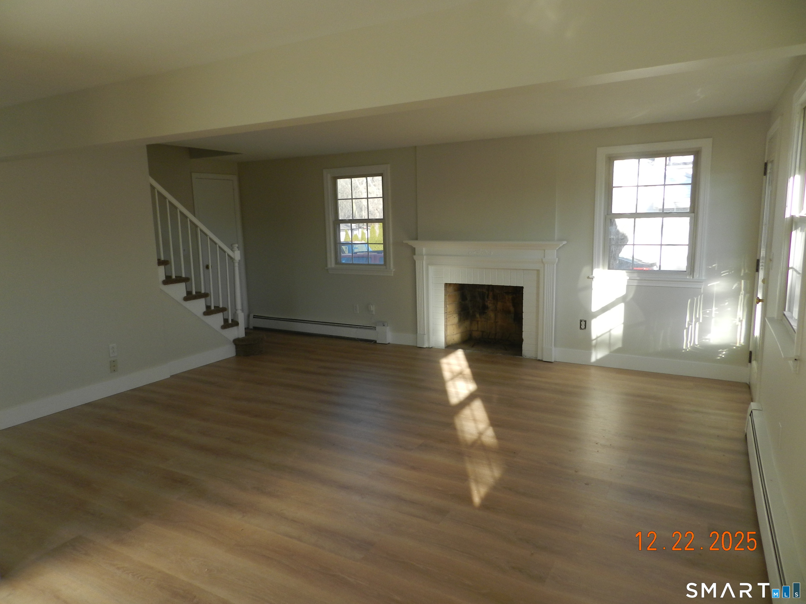 10 Poplar Street Windsor Locks, CT 06096 - Photo 4 of 9 a view of empty room with fireplace and wooden floor