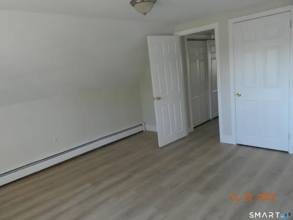 a view of an entryway with wooden floor