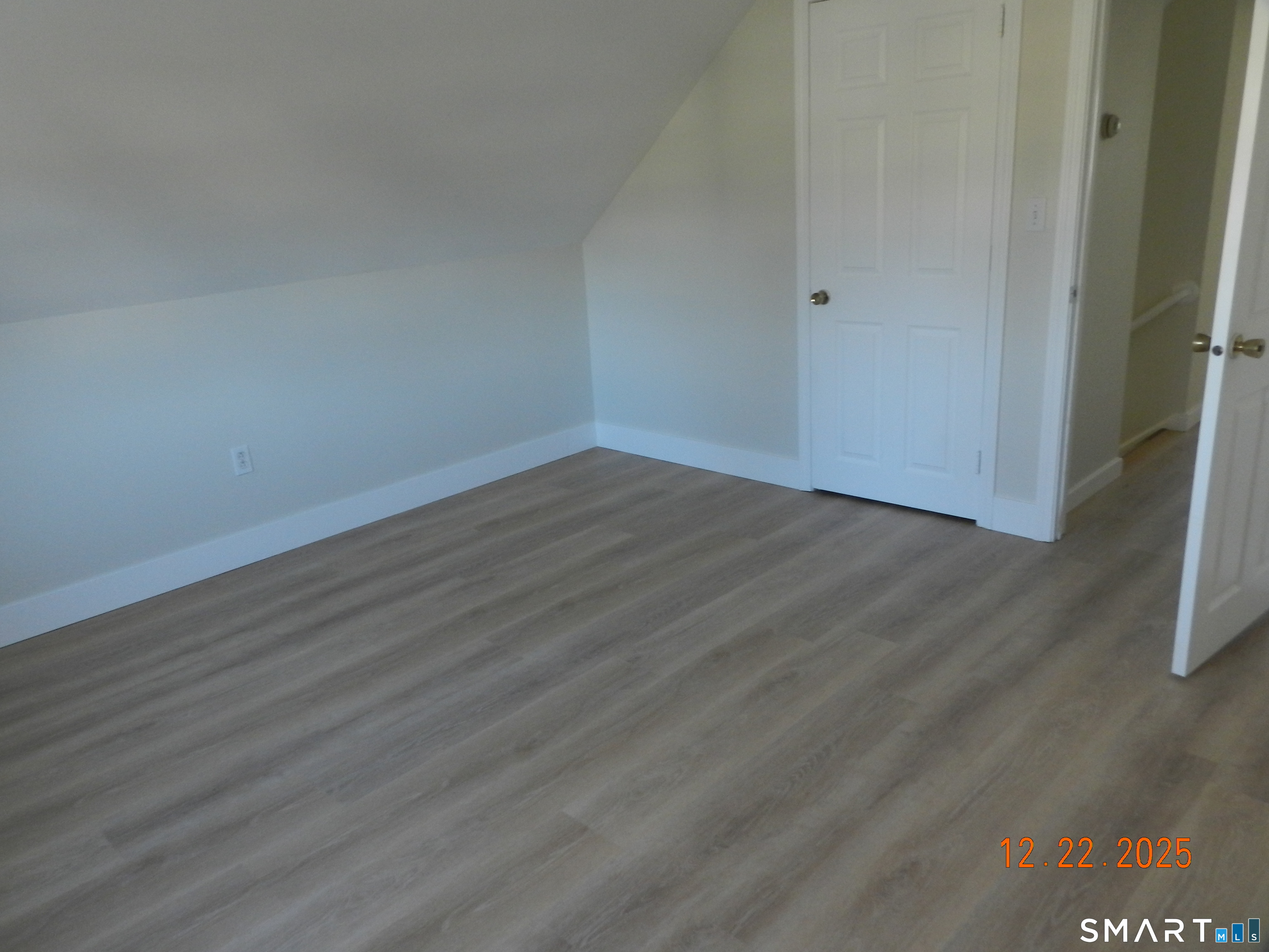 10 Poplar Street Windsor Locks, CT 06096 - Photo 7 of 9 a view of an empty room with wooden floor