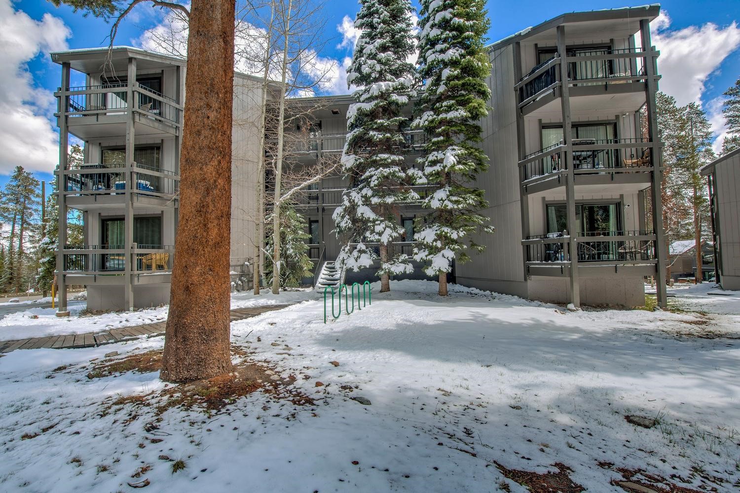 1075 Ski Hill Road, Unit 46 Breckenridge, CO 80424 - Photo 1 of 41 a front view of a building with a tree