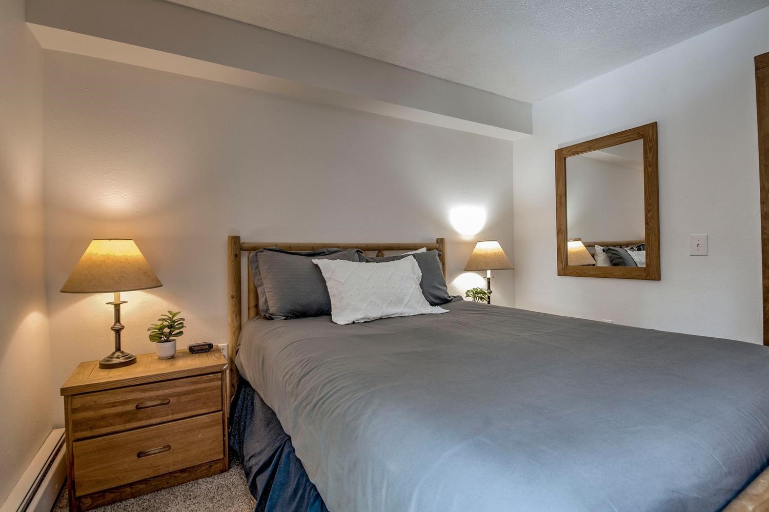 1075 Ski Hill Road, Unit 46 Breckenridge, CO 80424 - Photo 16 of 41 a bedroom with bed lamp and lamp