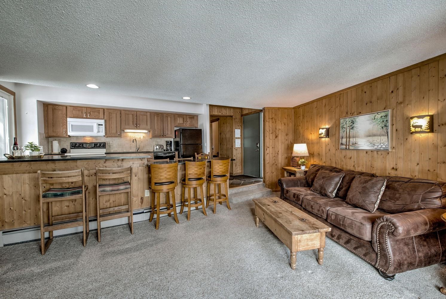 1075 Ski Hill Road, Unit 46 Breckenridge, CO 80424 - Photo 9 of 41 a living room with furniture and kitchen view