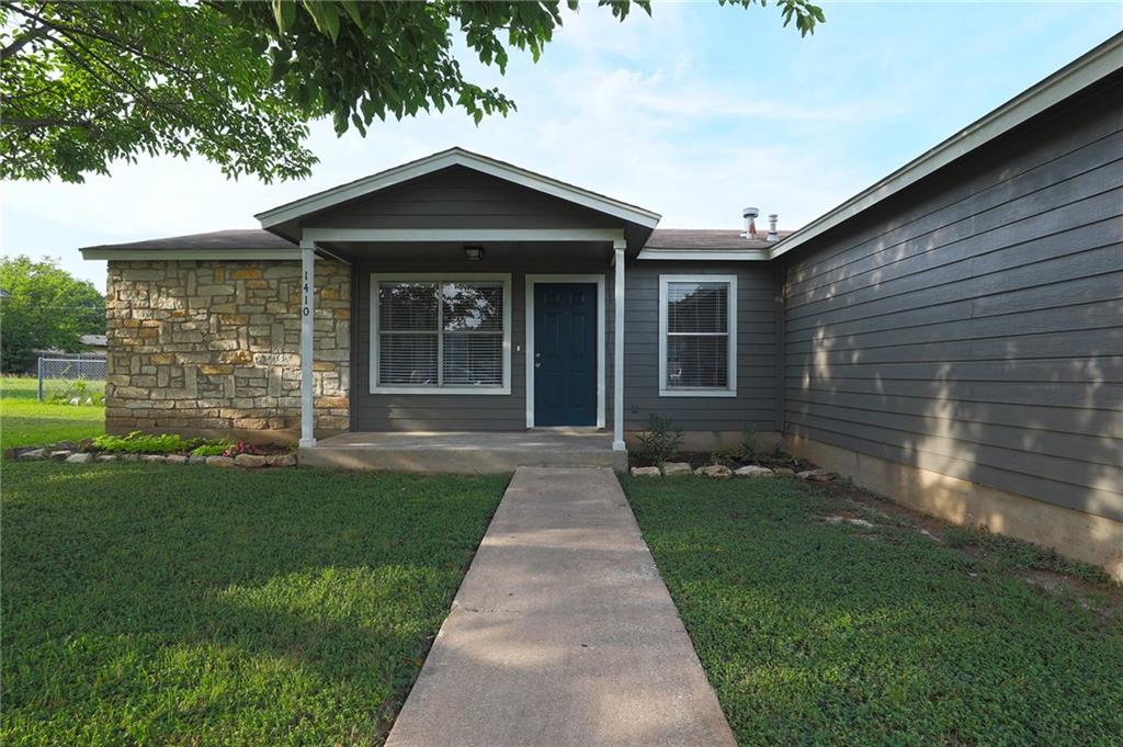 1410 Ransom Street Pflugerville, TX 78660 - Photo 2 of 22 a front view of a house with a garden