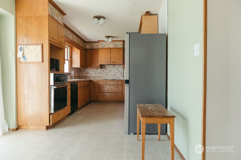 310 G Street Forks, WA 98331 - Photo 12 of 40 a kitchen with stainless steel appliances granite countertop a refrigerator and a stove