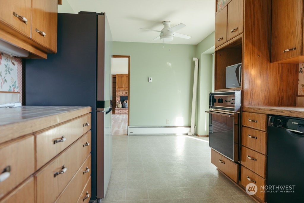 310 G Street Forks, WA 98331 - Photo 14 of 40 a kitchen with granite countertop a refrigerator and a stove