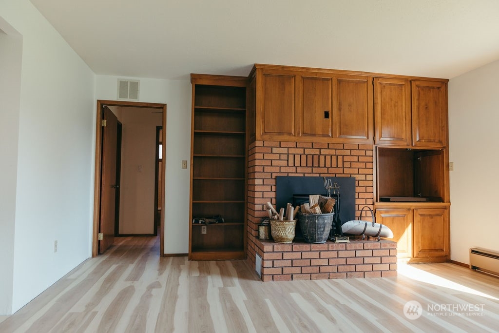310 G Street Forks, WA 98331 - Photo 7 of 40 a view of a livingroom with a fireplace and cabinet