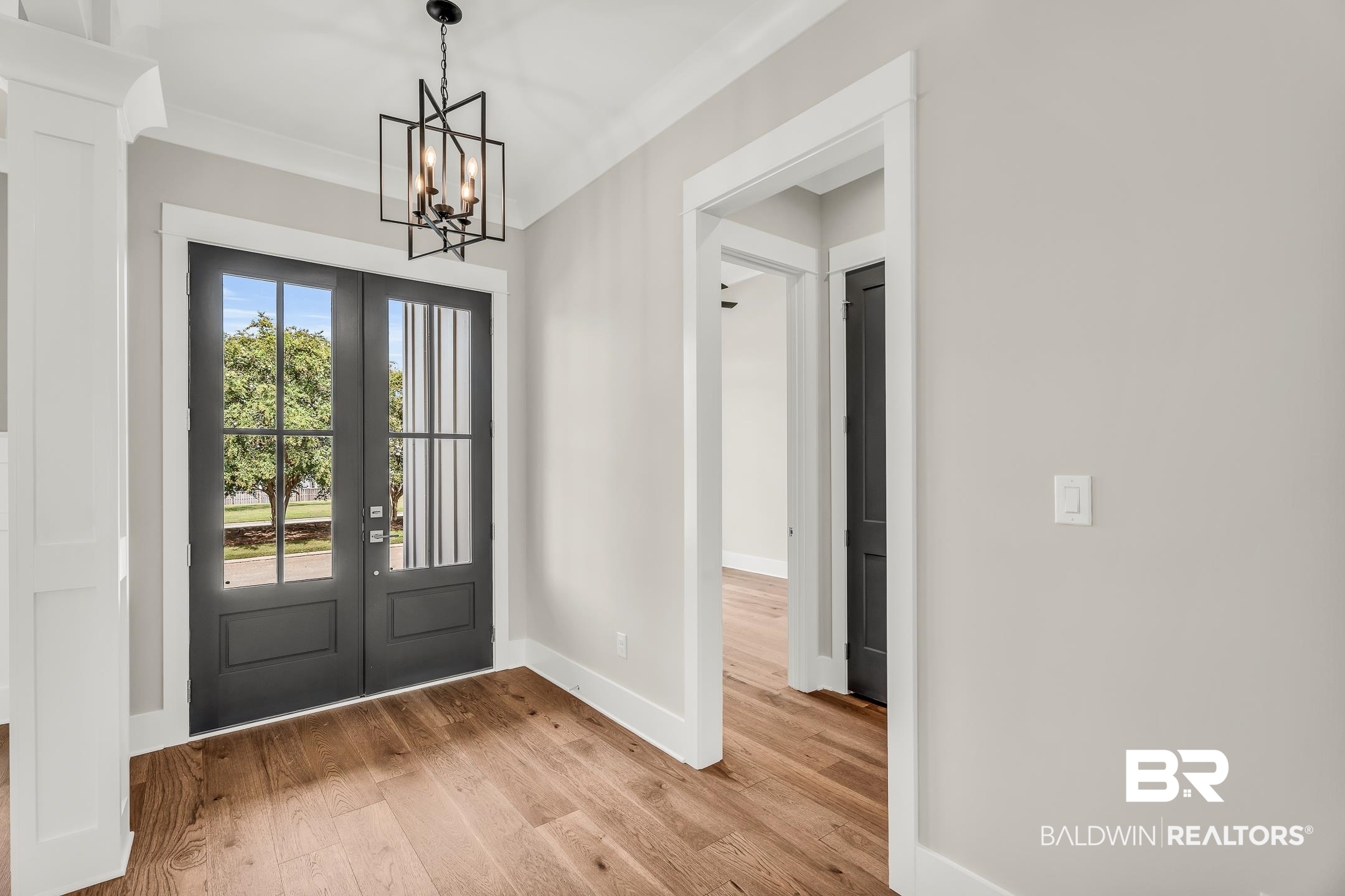 17786 Burwick Loop Fairhope, AL 36532 - Photo 24 of 57 Foyer with a chandelier, french doors, wood-type flooring, and ornamental molding