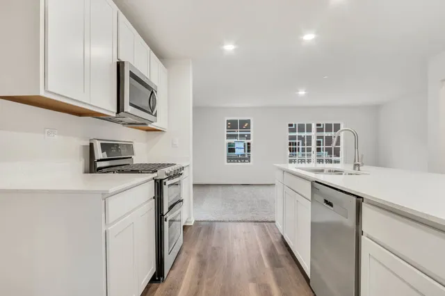 a kitchen with stainless steel appliances granite countertop a stove and a sink