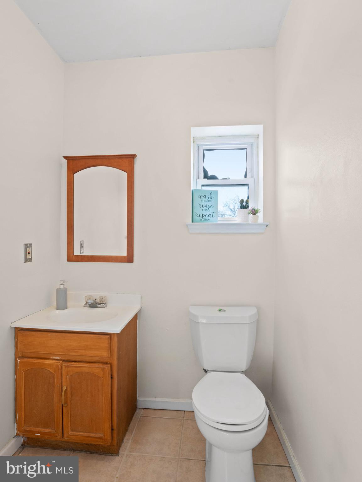 3014 Stevens Street Camden, NJ 08105 - Photo 12 of 34 a bathroom with a toilet a sink and mirror
