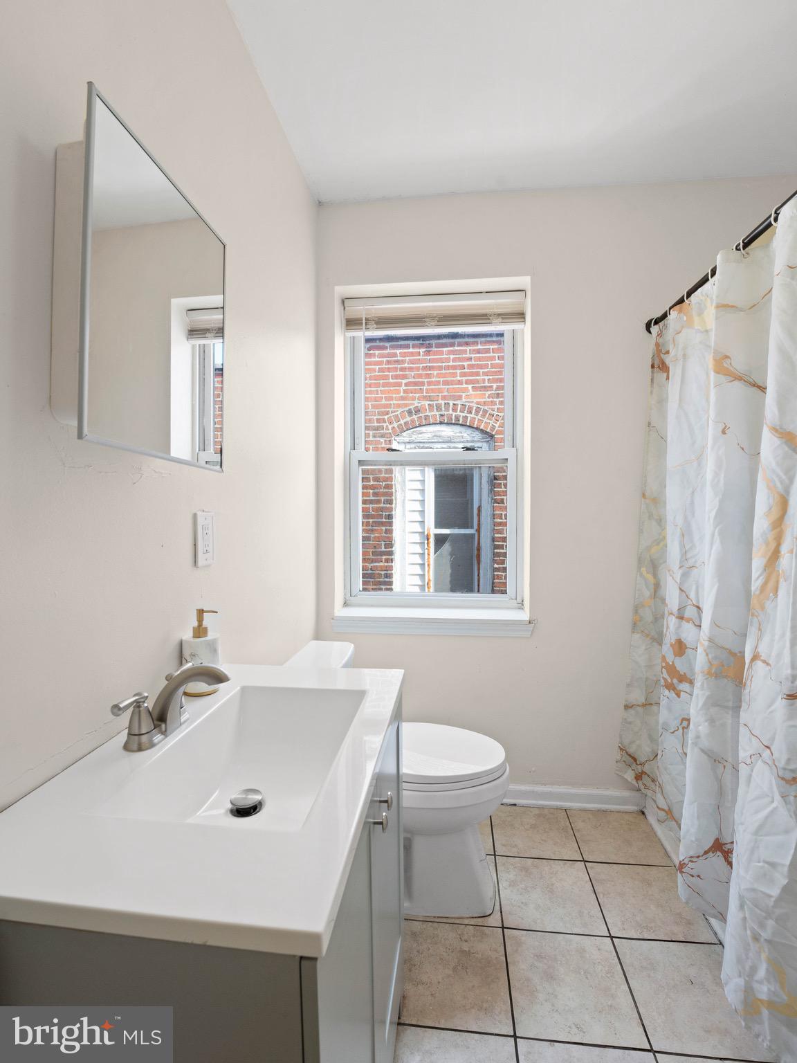 3014 Stevens Street Camden, NJ 08105 - Photo 19 of 34 a bathroom with a sink a toilet and a mirror
