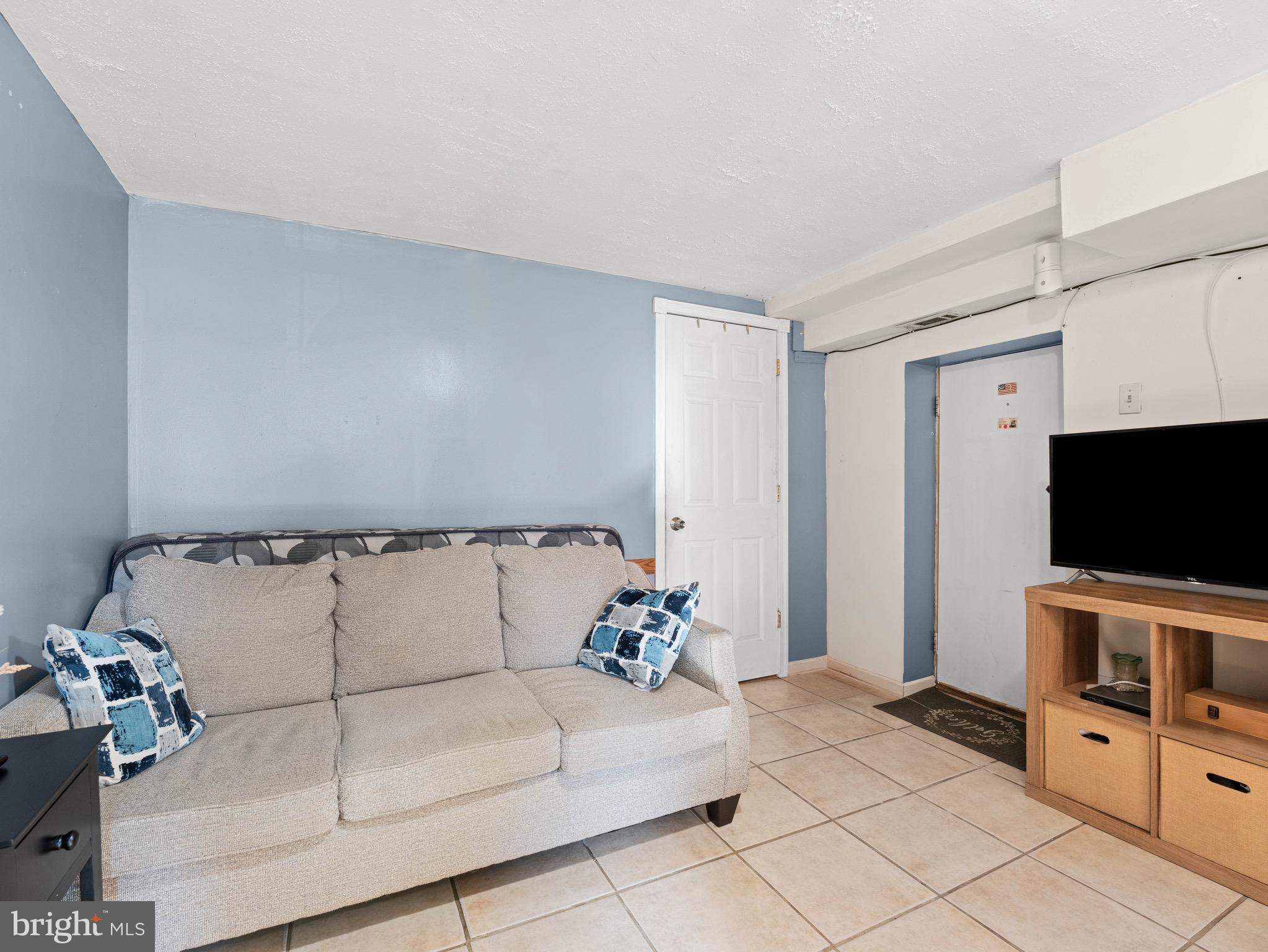 3014 Stevens Street Camden, NJ 08105 - Photo 21 of 34 a living room with furniture and a flat screen tv