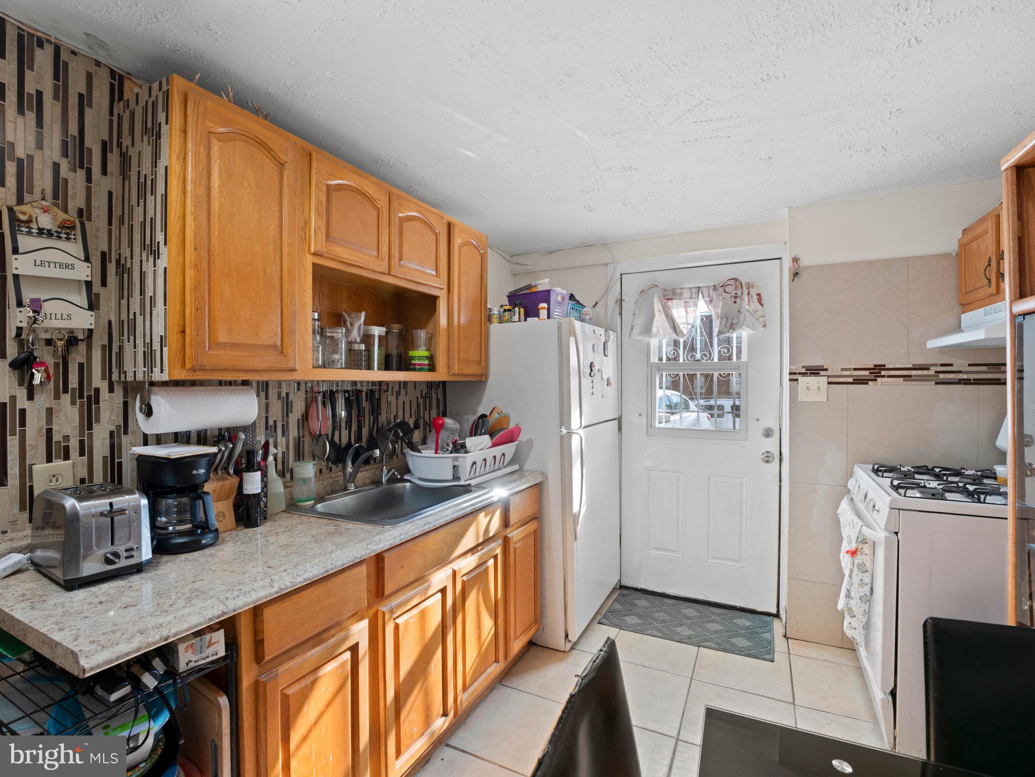 3014 Stevens Street Camden, NJ 08105 - Photo 23 of 34 a kitchen with refrigerator and cabinets