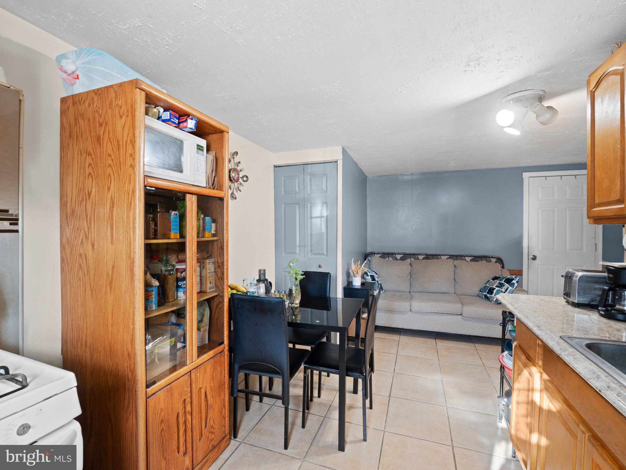 3014 Stevens Street Camden, NJ 08105 - Photo 24 of 34 a living room with furniture and a book shelf