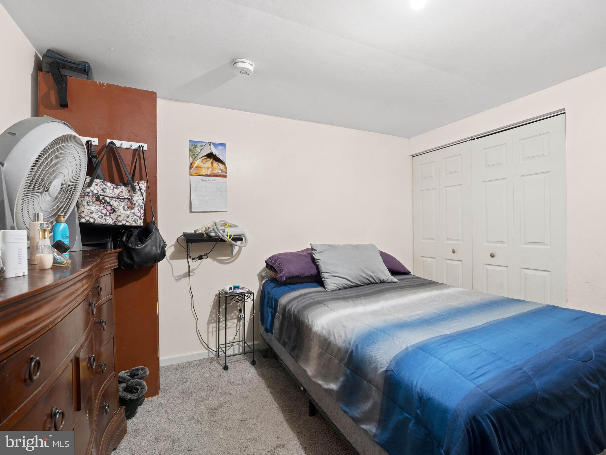 3014 Stevens Street Camden, NJ 08105 - Photo 26 of 34 a bedroom with a bed and a chandelier
